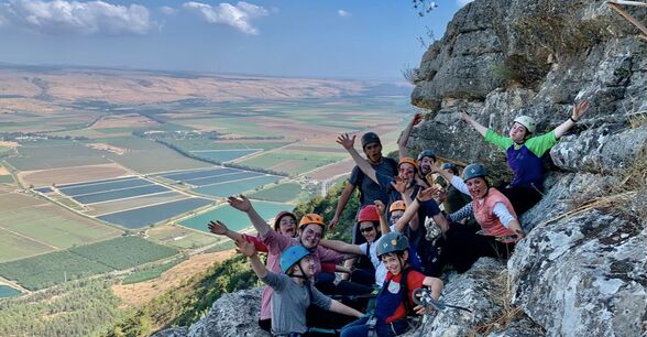 Family tour rappelling rock climbing on Manara Cliff, Israel